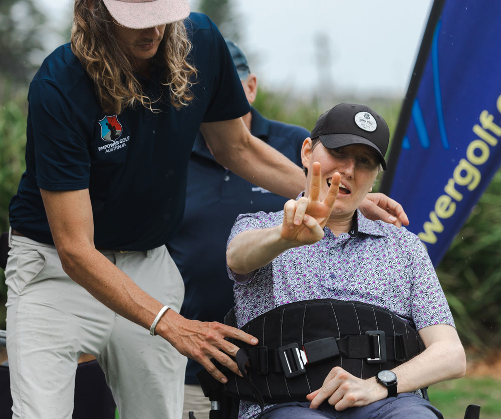 walkinshaw sports, image of coach with empower golf clinic participant