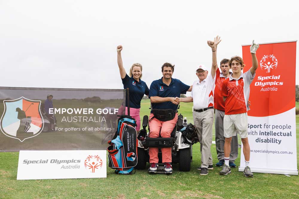 partnership with special olympics and empower golf, image of empower golf team with special olympics team shaking hands with banners and logos